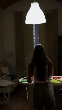 woman cooking in a kitchen at night