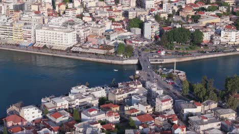 aerial footage of the old bridge of chalkida stretching over the evripos strait in the euboean gulf — a historic landmark and symbol of the city’s identity.