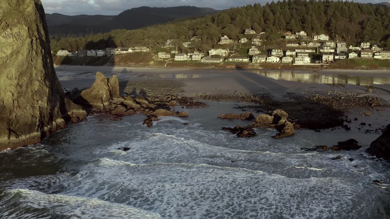Cannon Beach, pullback aerial of Haystack Rock at sunset, Oregon