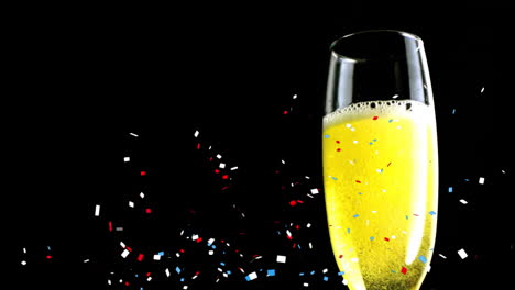 Animation-of-confetti-falling-over-champagne-glass