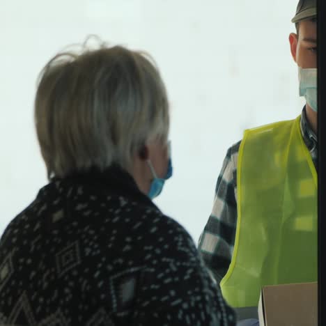 courier brings food bags to elderly woman's home 2
