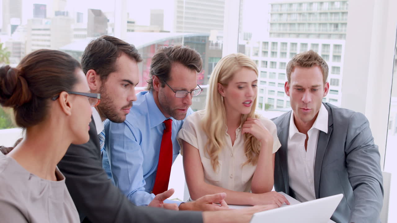 Business people working together at meeting on laptop