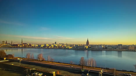 all day and night time lapse of the riga, latvia city skyline from across the daugava river