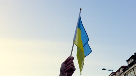 Ukrainian-flag-being-waved-at-a-protest,-Prague,-close-up-slow-motion