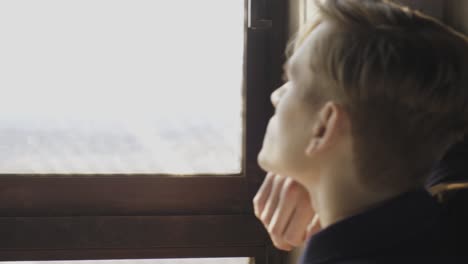 young male standing near windows