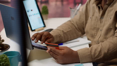 successful freelancer does online shopping with his credit card