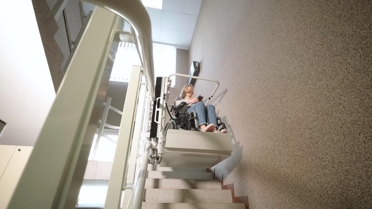 A girl in a wheelchair effortlessly ascends the stairs using a stair lift.