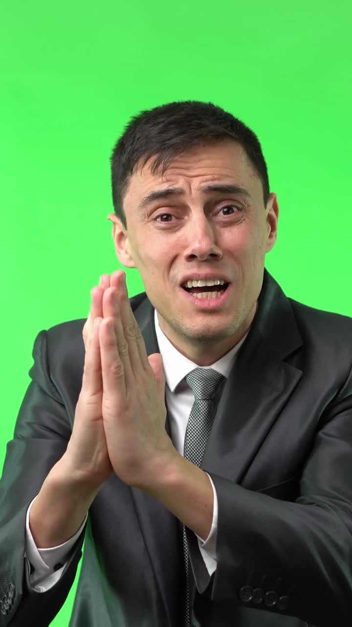 Emotional Man in Suit Pleading on Green Screen