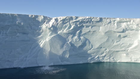 a waterfall flows off the austfonna icecap in norway suggesting global warming