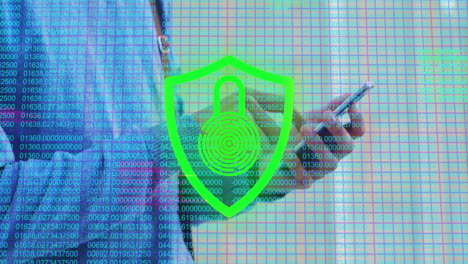 animation of fingerprint padlock in shield and grid pattern over caucasian man using cellphone