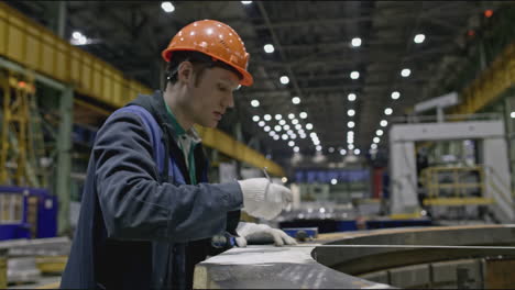 factory worker performing inspection in a manufacturing facility