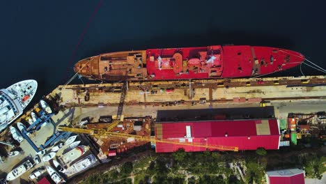 incredible bird's-eye view from a drone of a bustling port, complete with gigantic ships and towering cranes