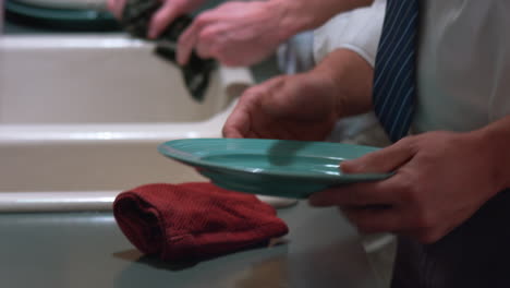 washing dishes cleaning the plate and drying the plate and counter top