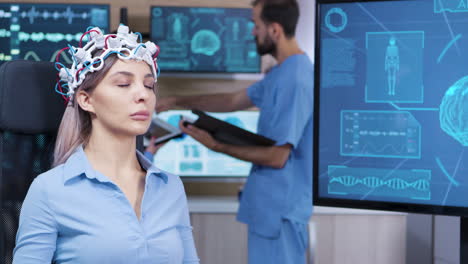 brain activity on tv screen from female patient with brainwaves scanning headest