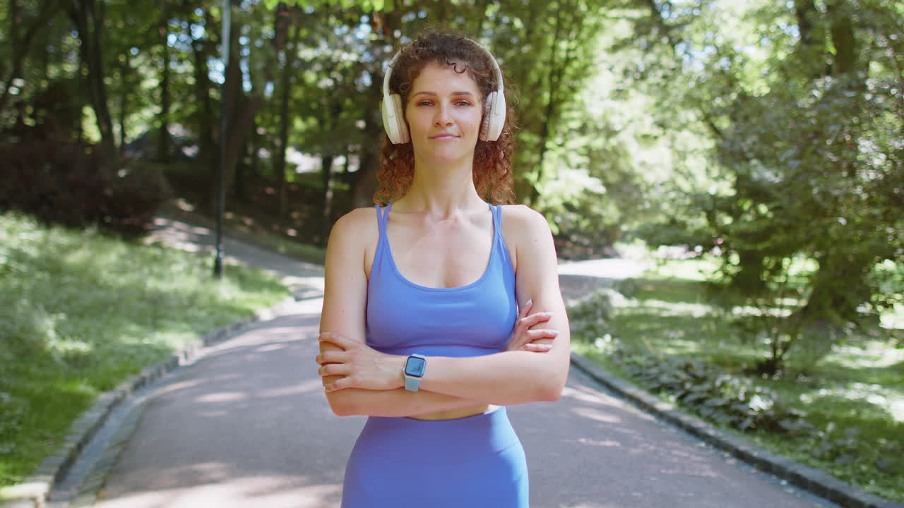 Woman on a park path wearing fitness gear