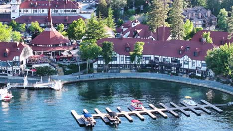 lake arrowhead village telephoto aerial compression over the village and marina with boat docks on a sunny summer day with dramatic shadows - aerial orbit