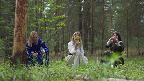 teenage girl looks at sprout picking herbs with friends