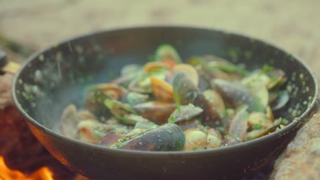 cooking fresh seafood on a campfire