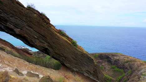 Panorámica-Aérea-E-Inclinación-Toma-De-Drones-Toma-De-Drones-Del-Arco-Del-Cráter-De-Koko-Con-El-Océano-Pacífico-En-El-Fondo---Oahu-Hawai