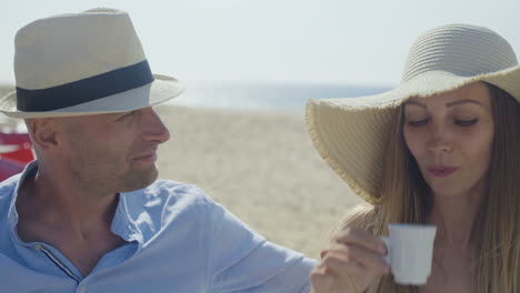 man looking at girlfriend drinking coffee