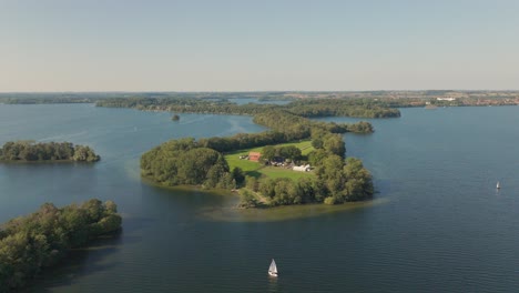 princes island prinzeninsel plön on warm sunny day with gentle water and sail boat