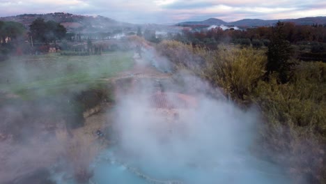 the geothermal thermal hot springs bath and waterfall at saturnia, tuscany italy close to siena and grosseto by sunrise