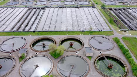 aerial shot of a wastewater treatment plant and distant skyline. big city waste processing concept