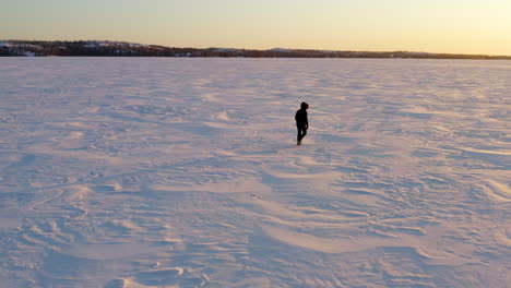 One-man-walking-in-snow-desert-in-wilderness,-yellowknife-canada