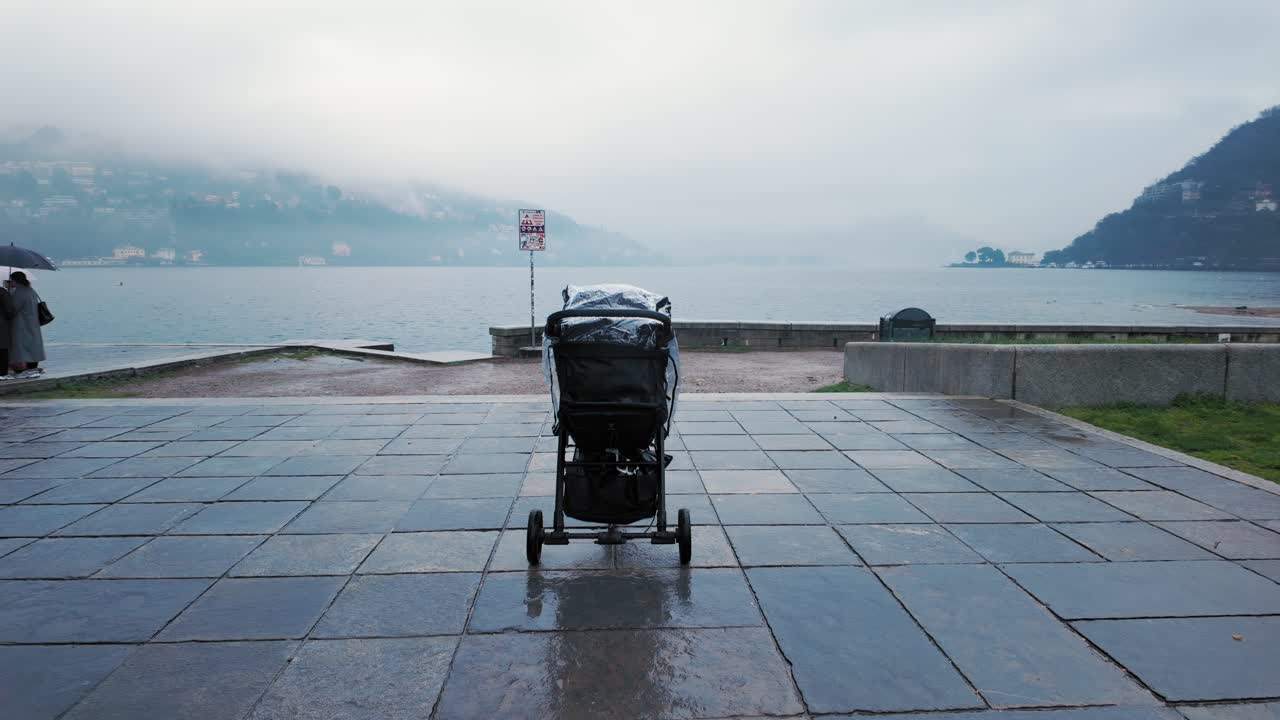 Isolated baby stroller on a rainy day near the shore