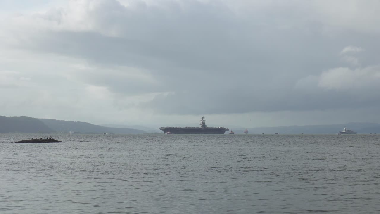 Navigating Aircraft Carrier USS Gerald R. Ford In Oslo Fjord, Oslo, Norway. Aerial Shot