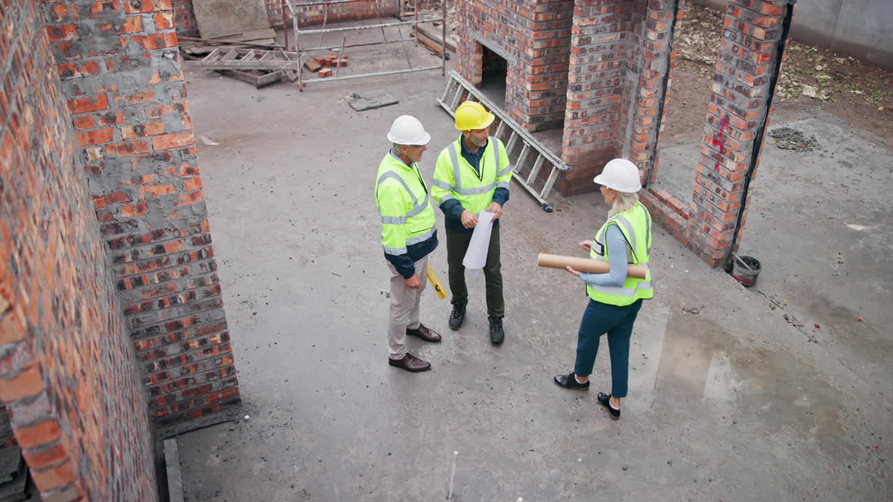 Construction site with workers reviewing blueprints