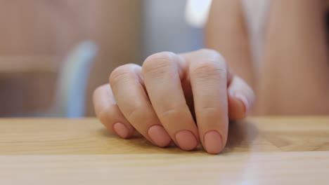 impatient person tapping on the table with fingers