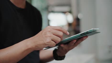 young man working on tablet close up shot