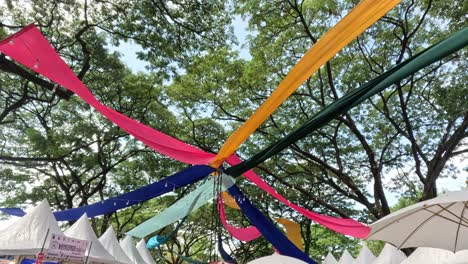 vibrant banners waving against a tree backdrop.