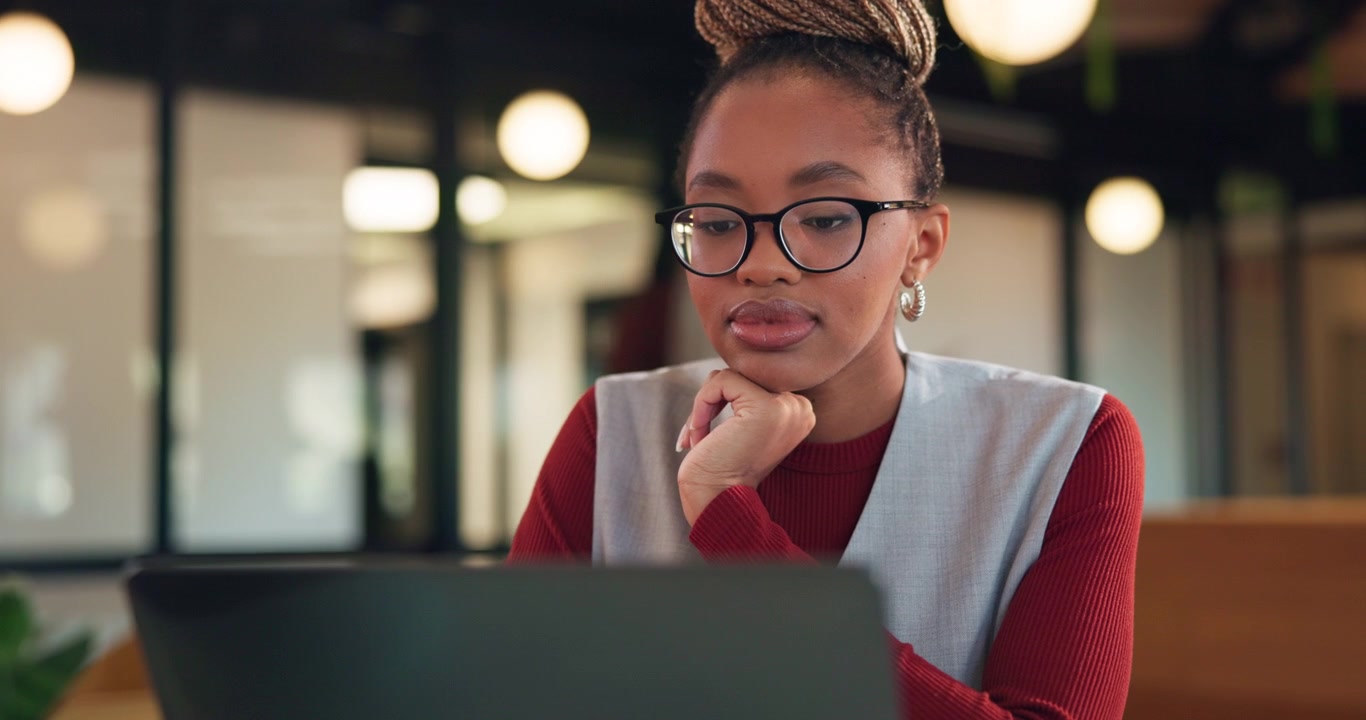 Young Professional Woman Working on Laptop in Modern Office