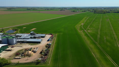 The-vast-expanse-of-the-farmland-is-captured-from-an-aerial-perspective,-showcasing-its-remarkable-infrastructure-and-well-equipped-processing-area