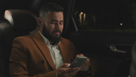 business man texting messages in car