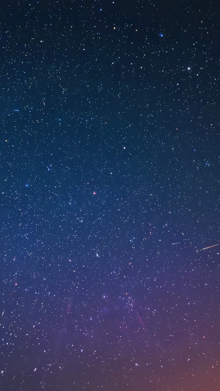 Vertical video: Recording camera capturing starry night sky over rural land, with horizon glow