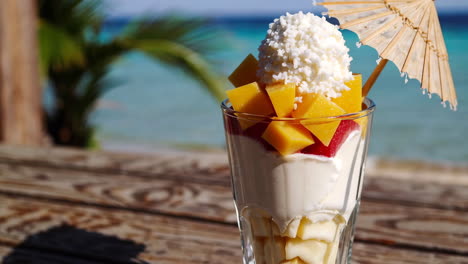 tropical fruit parfait on a beach
