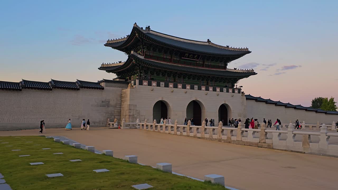 Tourists Enter and Exit Gwanghwamun Gate of Gyeongbokgung Palace in Seoul at Sunset