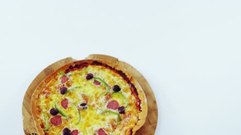 baked pizza on wooden board