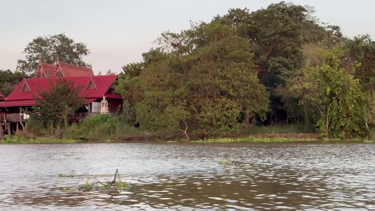 Riverfront Houses with Red Roofs in Thailand