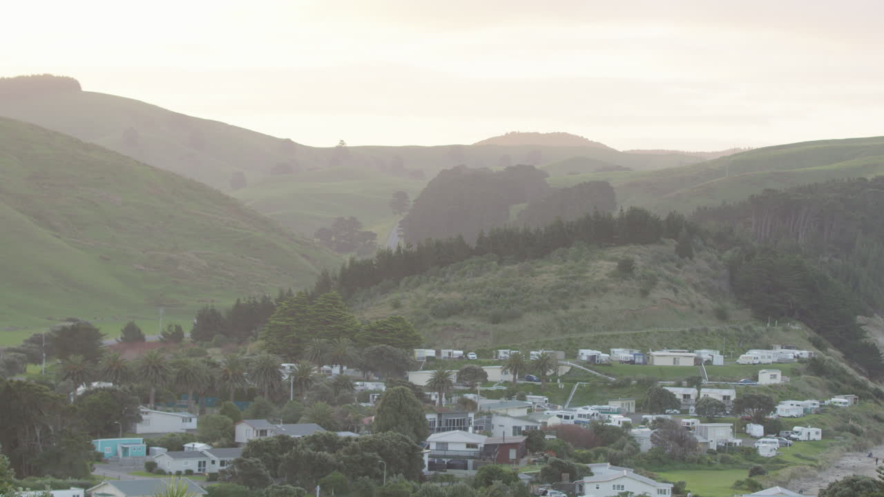Pan shot of a neighbourhood at sunset of New Zealand's farmland in the Wairarapa