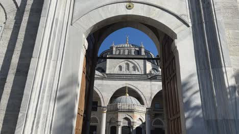 Suleymaniye-Mosque-entrance,-walk-through-grand-arch-way-into-courtyard