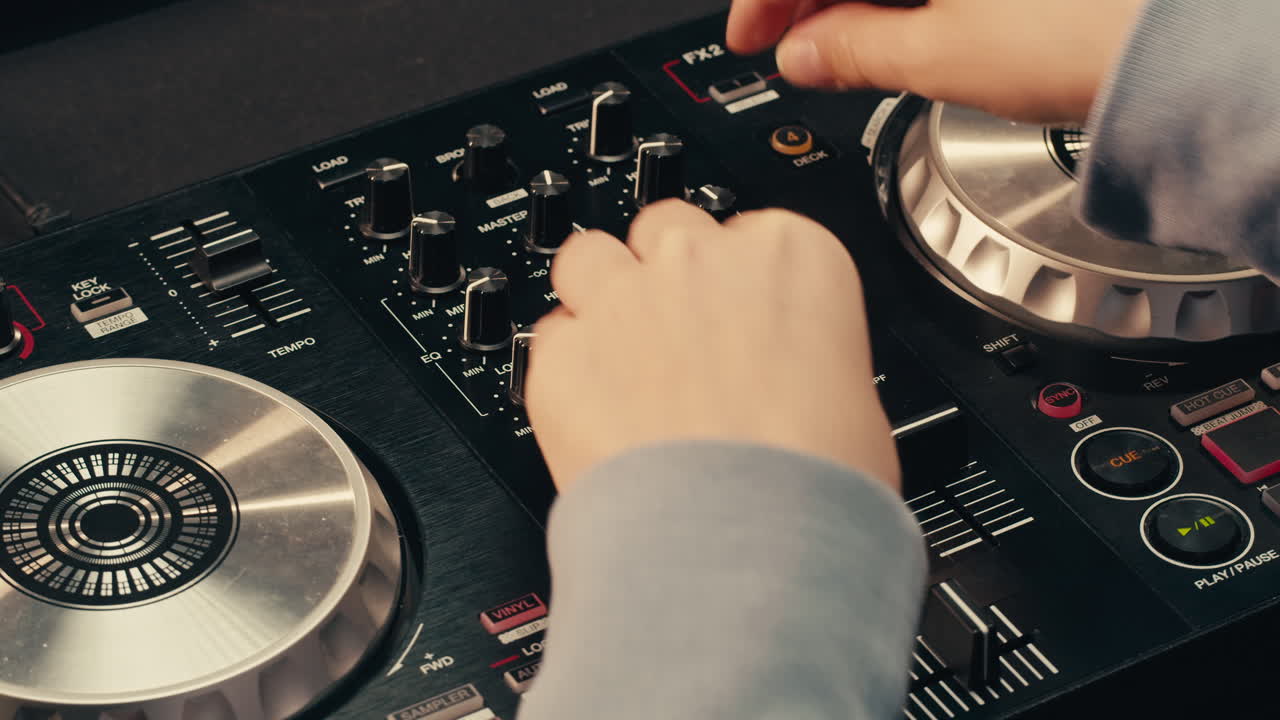DJ with headphones and sunglasses playing music on festival in night club. Techno musician performing at nightclub for concert crowd of people, city bar.