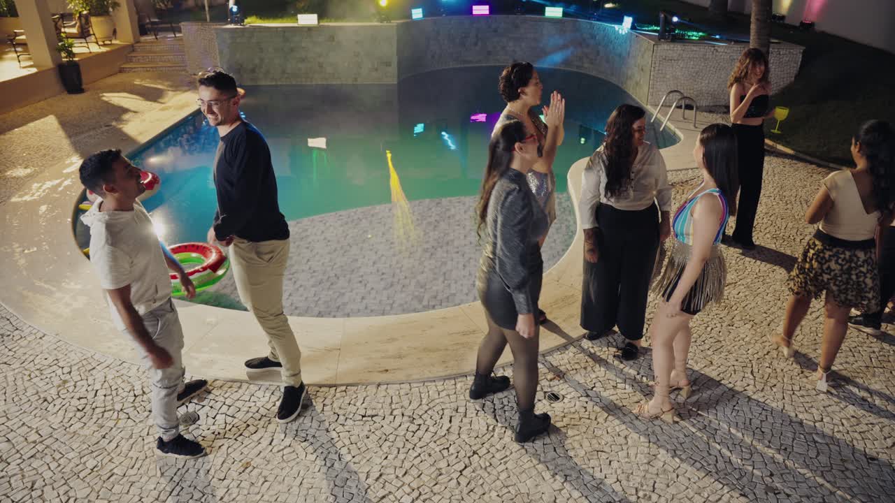 Lively Nighttime Pool Party with Friends