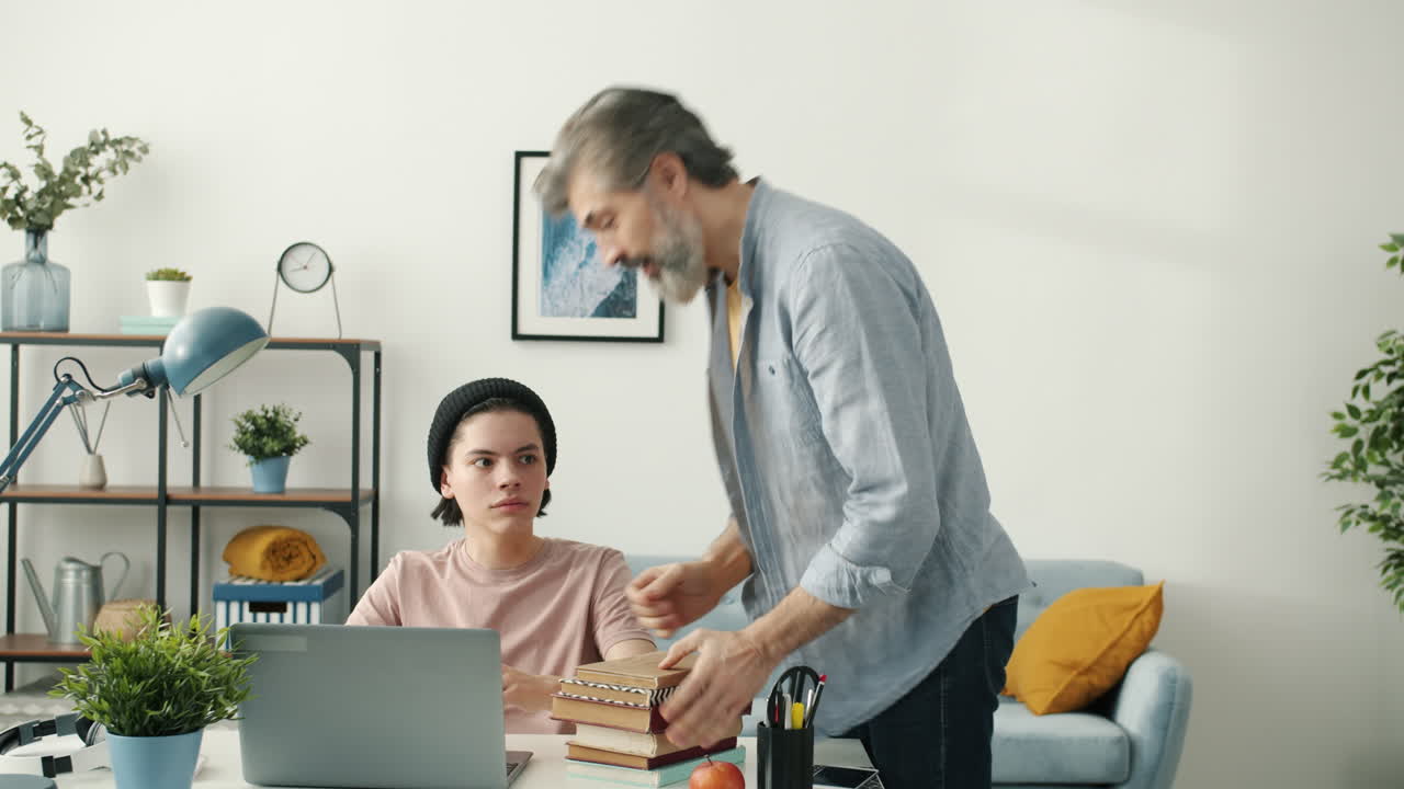 Father helping his teenager with homework