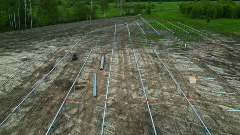 installing pole mounts for photovoltaic solar panels in a farmland