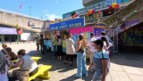 people socializing outside a food stall