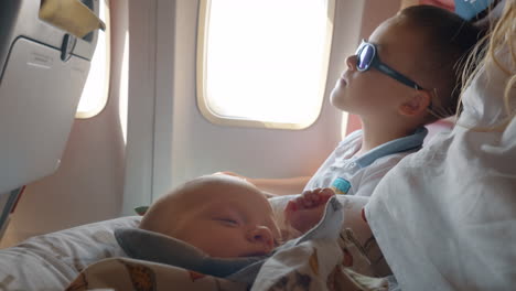 family with baby and elder son traveling by air